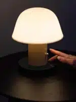 Nordic retro mushroom table lamp with warm LED glow on a bedside table