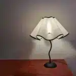 Elegant handmade petal lampshade casting a warm glow in a cozy bedroom
