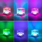 3D pyramid night light with RGB color modes on a bedside table
