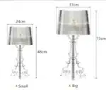 Modern acrylic table lamp glowing softly on a bedside table in a contemporary bedroom