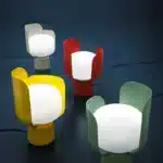 Rotating petal desk lamp with adjustable petals in pastel colors on a bedside table