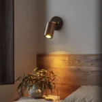 Walnut bedside wall light with adjustable spotlight and zipper switch in a cozy bedroom