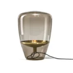 Modern table lamp with glass shade on bedside table