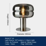 Modern table lamp with glass shade on bedside table