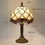 Vintage table lamp with handmade colored glass shade casting warm ambient light