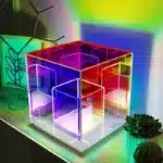 3D pyramid night light with RGB color modes on a bedside table
