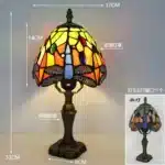 Tiffany table lamp with colorful stained glass shade casting warm glow on nightstand