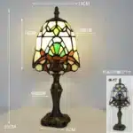 Tiffany table lamp with colorful stained glass shade casting warm glow on nightstand