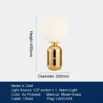 Modern table lamp with glass shade on bedside table