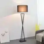Modern floor lamp with iron frame and fabric shade in a contemporary living room