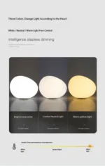 Warm night light pebble LED lamp glowing on a bedside table