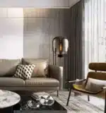 Modern floor lamp with iron frame and glass shade in a cozy living room