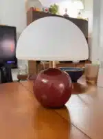 Mushroom table lamp with cream ceramic shade on bedside table