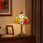 Vintage table lamp with handmade colored glass shade casting warm ambient light