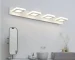 Round LED wall lamp with acrylic shade in a modern living room