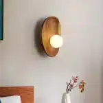Vintage wall sconce with wooden backplate and clear glass shade, warm light