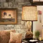 Vintage table lamp with hemp rope and iron base, emitting warm light on a bedside table