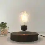 Floating LED lamp with levitating bulb on a wooden desk in a modern living room