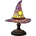 Witch hat lamp with stained glass pattern casting a warm glow on a bedside table