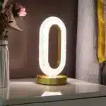 Elegant oval crystal table lamp with USB charging on a bedside table