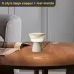 Elegant marble table lamp with soft glow on bedside table in bedroom