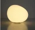 Modern table lamp with warm glow on bedside table