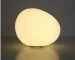 Modern table lamp with warm glow on bedside table