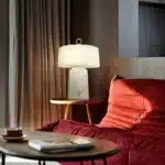 Elegant marble table lamp with soft glow on bedside table in bedroom