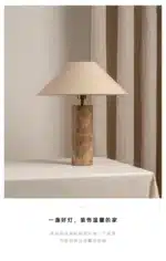 Modern marble LED table lamp with white fabric shade on wooden desk