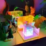 3D pyramid night light with RGB color modes on a bedside table
