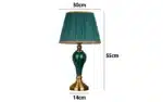 Green ceramic table lamp with European cloth shade in a modern living room setting