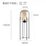 Modern floor lamp with iron frame and glass shade in a cozy living room