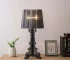 Modern acrylic table lamp glowing softly on a bedside table in a contemporary bedroom