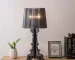 Modern acrylic table lamp glowing softly on a bedside table in a contemporary bedroom