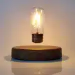 Floating LED lamp with levitating bulb on a wooden desk in a modern living room