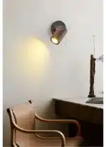 Walnut bedside wall light with adjustable spotlight and zipper switch in a cozy bedroom