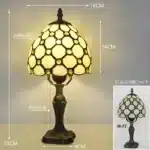 Tiffany table lamp with colorful stained glass shade casting warm glow on nightstand