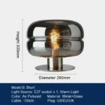 Modern table lamp with glass shade on bedside table