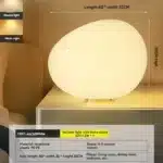 Modern table lamp with warm glow on bedside table
