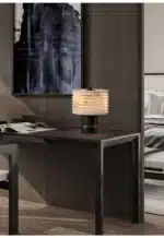 Elegant marble table lamp with soft glow on bedside table in bedroom