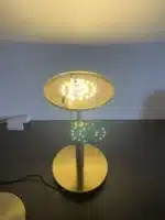 White glass table lamp with vintage design on a wooden desk in a cozy bedroom