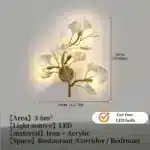 Luxury gold leaf sconce with modern ginkgo design illuminating a living room wall