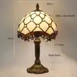 Vintage table lamp with handmade colored glass shade casting warm ambient light