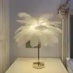 Ostrich feather table lamp glowing warmly on a bedside table in a cozy bedroom