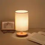 Modern linen table lamp with USB port and touch control on bedside table