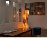 Wooden floor lamp with warm glow in a cozy living room
