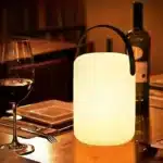 Cordless table lamp with RGB LED lighting on a patio table