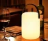 Cordless table lamp with RGB LED lighting on a patio table