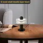 Elegant marble table lamp with soft glow on bedside table in bedroom