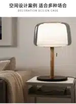 Modern bedside lamp with cream glass shade on a nightstand